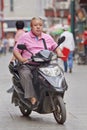 Overweight man on an e-bike, Beijing, China Royalty Free Stock Photo